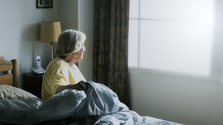 Senior woman having a self-isolation in a bedroom
